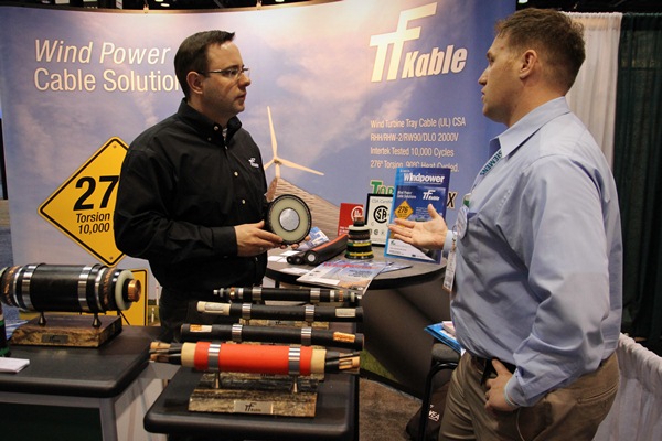 First stop of the day: Windpower Engineering and Development sales manager Neel Gleeson speaks with Pawel Kolek of TF Kable. Kolek is holding a 500-kV rated cable the company developed to supply a growing need in the industry.