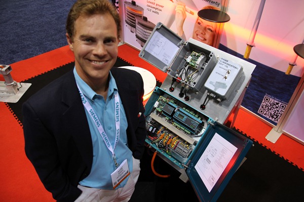TWR Lighting’s Harris Pratka stands with the company’s Radar Ethernet Interface, which turns aviation lights on if an airplane flies within three miles of a turbine.
