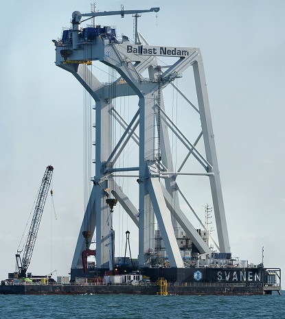 The size and displacement of the Ballast Nedam drilling rig presented complicated engineering problems to the Anholt wind farm construction crew. They had to remove boulders from wind turbine monopile sites, and the rig could only travel and operate in seas with a maximum 3-ft wave height. Engineers had to determine optimal cable tensions for securing it during transit, avoid collisions between parts, erect it on the monopile sites, and secure it at proper operating angles.