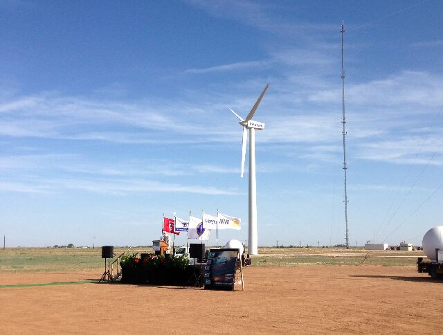 A retrofitted wind turbine serves as backdrop for the commissioning event where Kent Hance, Chancellor of the Texas Tech University System spoke to the group. The turbines contain ABB wind converters and Baldor induction generators. The tower in the background measures wind velocity, while the white Doppler Radar domes further serve to study how wind conditions affect the turbine performance: 