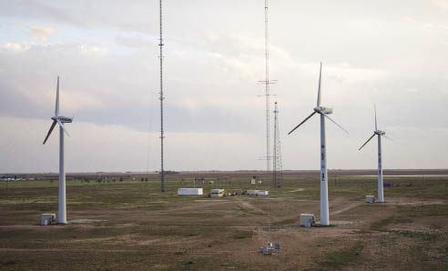 Sandia’s SWifT facility in west Texas has three turbine up and ready for experiments. The rebuilt Vesta units have new drive trains and open-sourced controls for easy adjustments and tests. Director John White says the facility is open to serious component developers who would like to test their equipment and ideas in the real world. The finished facility will have about 10 turbines arranged roughly in a square.