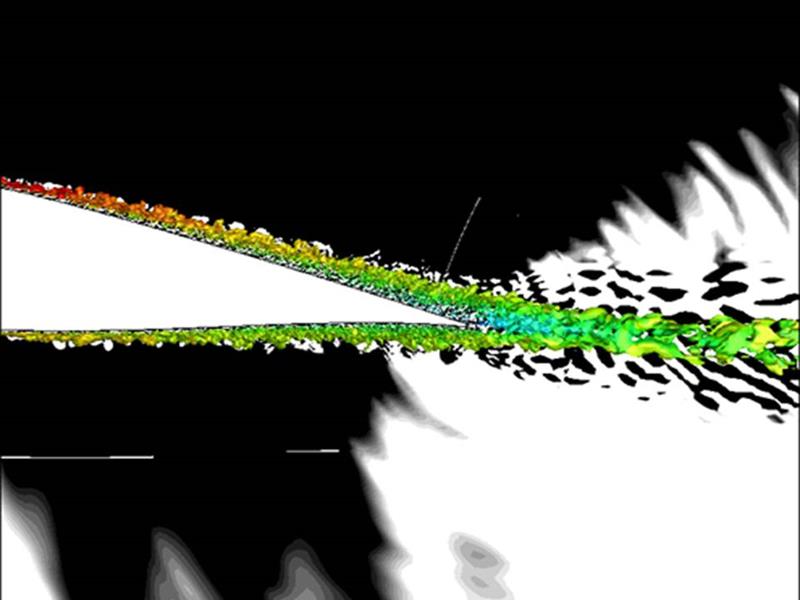 White areas suggest noise generation from turbulent flow over the trailing edge of a wind-turbine airfoil. Dilatation contours from a Large Eddy Simulation are shown in the background. (Courtesy: Prof. Lele, Stanford University)