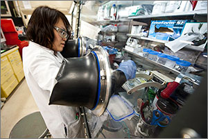 NREL Scientist Chunmei Ban assembles a lithium-ion battery in the materials lab at the Solar Energy Research Facility at NREL.