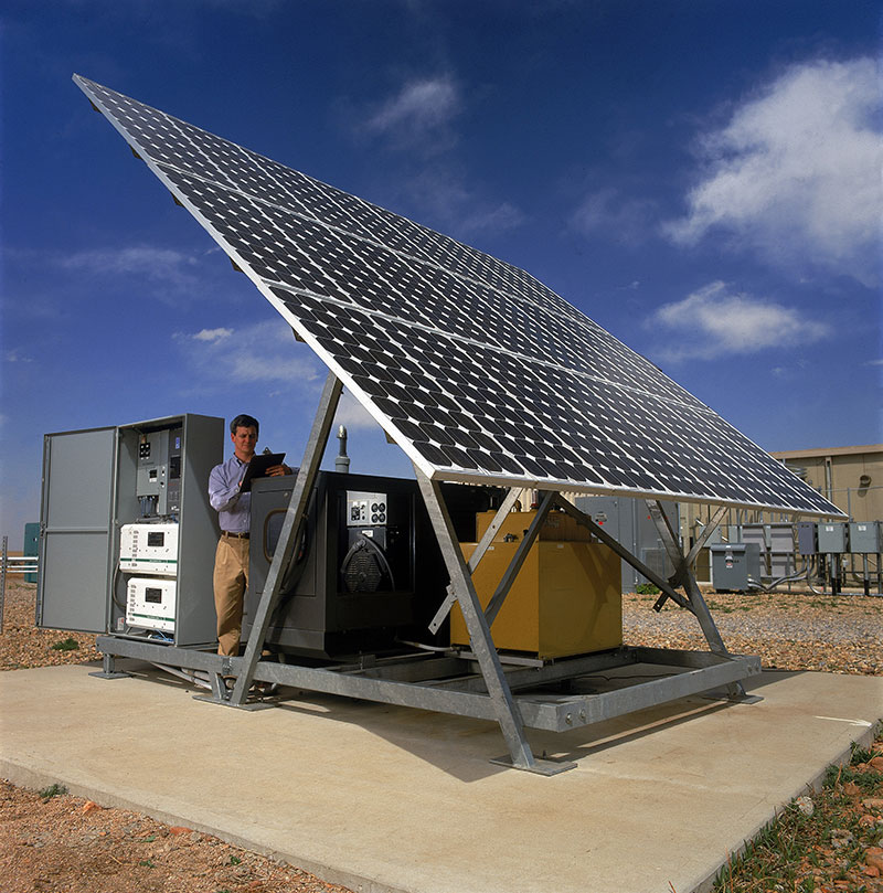 This standalone photovoltaic system at NREL's Distributed Energy Resources Test Facility creates a mini-grid wherever it goes and creates enough power to run a small home. It consists of a 1.8-kilowatt photovoltaic panel, a diesel generator for backup, and inverters to convert DC power to AC. This generation system is connected to other generation technologies like wind turbines and a microturbine to test interconnection. Photo: Jim Yost 