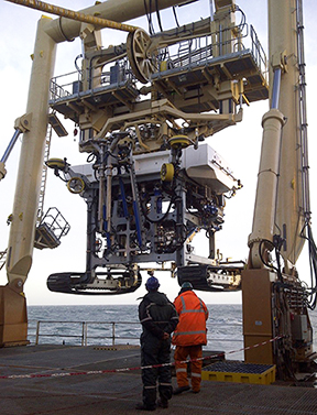 Workers begin the launch of the Fugro Q1400 trenching system.