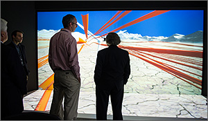 NREL Senior Engineer Pat Moriarty, left, explains a wind turbine model at the ESIF Insight Center to Secretary of Energy Ernest Moniz, right, during a tour for the dedication of the ESIF last year.