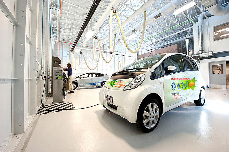 NREL scientist Michael Kuss of the NREL Electric Vehicle Grid Integration Team reads data from test electric vehicles at the Vehicle Testing and Integration Facility.