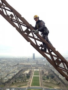 At work: climbing the Eiffel Tower during installation of the vertical-axis wind turbines.