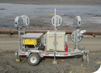 DeTect sound makers, a CNRL Merlin detect and deter system, are activated by avian radar (not shown). This unit is working at a pond in Fort McMurray, Alberta, Canada.