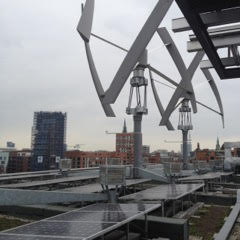 The Greenpeace building in Hamburg, Germany includes rooftop solar and wind power, and the office even taps into geothermal energy--a good example of working together.