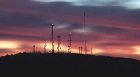 Transmission Towers on a Mountain Ridge at Sunset