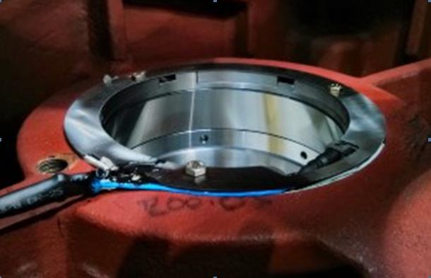 When a bearing is subject to a load, its thickness is reduced by a small amount due to elastic deformation, which also affects the speed of sound by the stress level in the material.