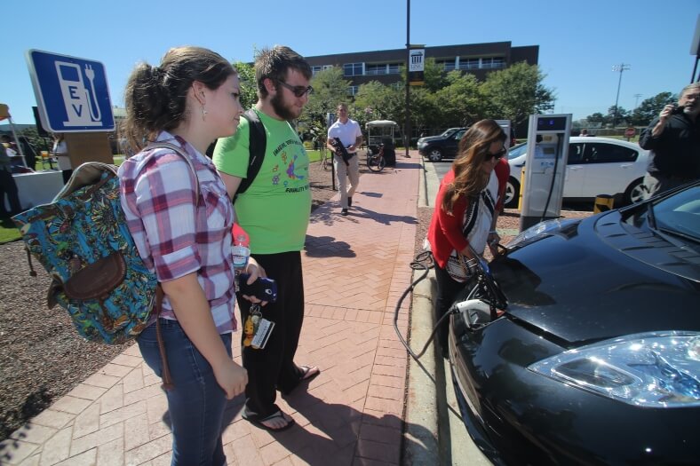 UNC Pembroke students look on as Ashley Fiala demos how to charge a PEV. | Photo W. Glassgow
